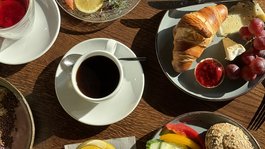 Seeblick: holidays by the lake in North Rhine-Westphalia Breakfast table with coffee, croissant, cheese, cold cuts, and fruit juices