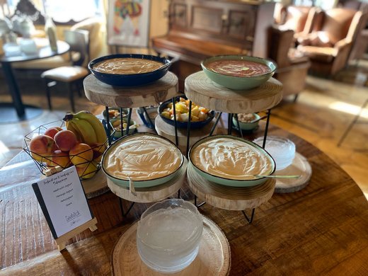 Breakfast at our restaurant Seeblick in Gronau Yogurt and fresh fruit on wooden trays in a cozy room
