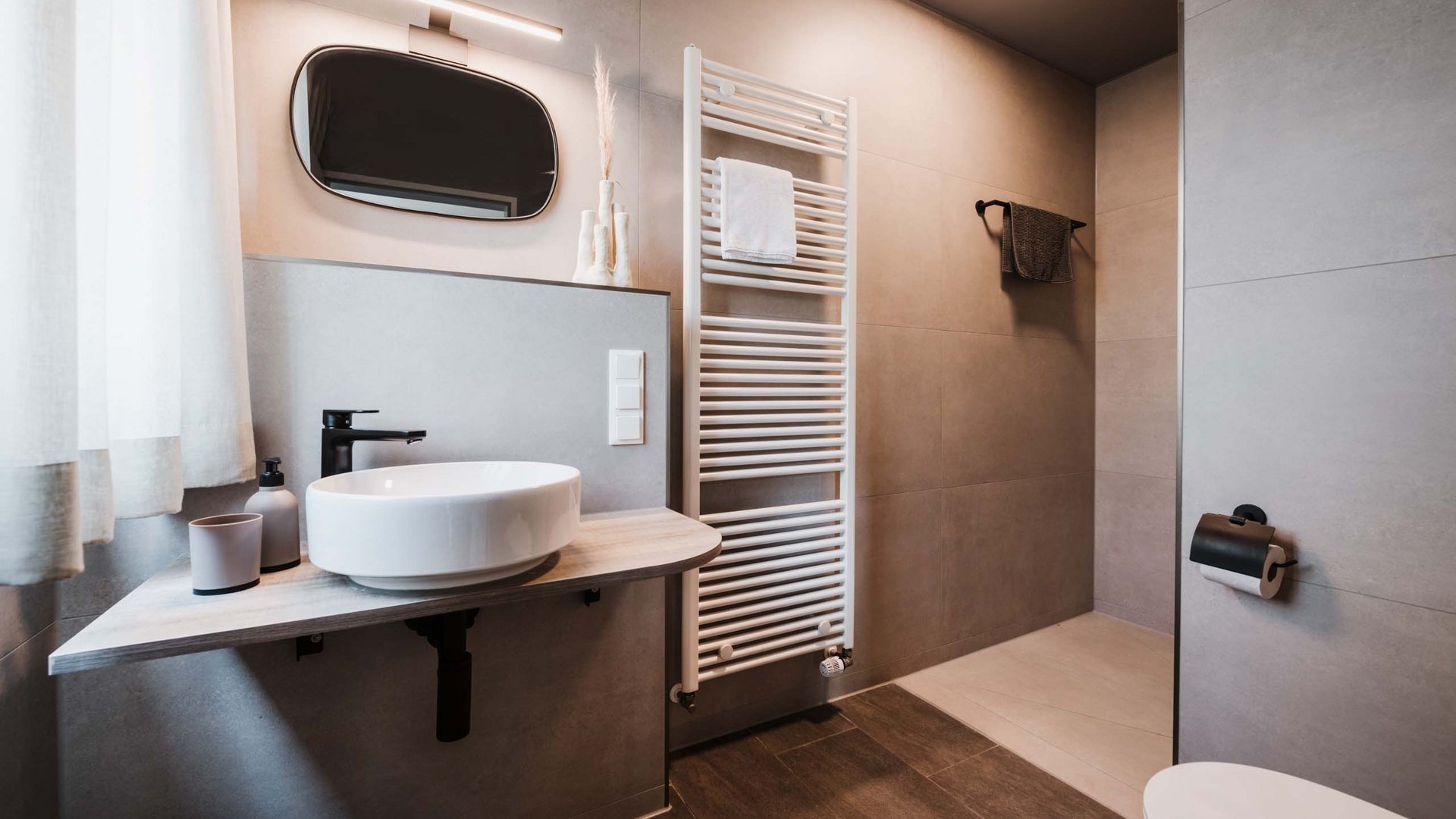Seeblick: Ferienwohnungen Gronau Modernes Badezimmer mit rundem Waschbecken und Handtuchheizung